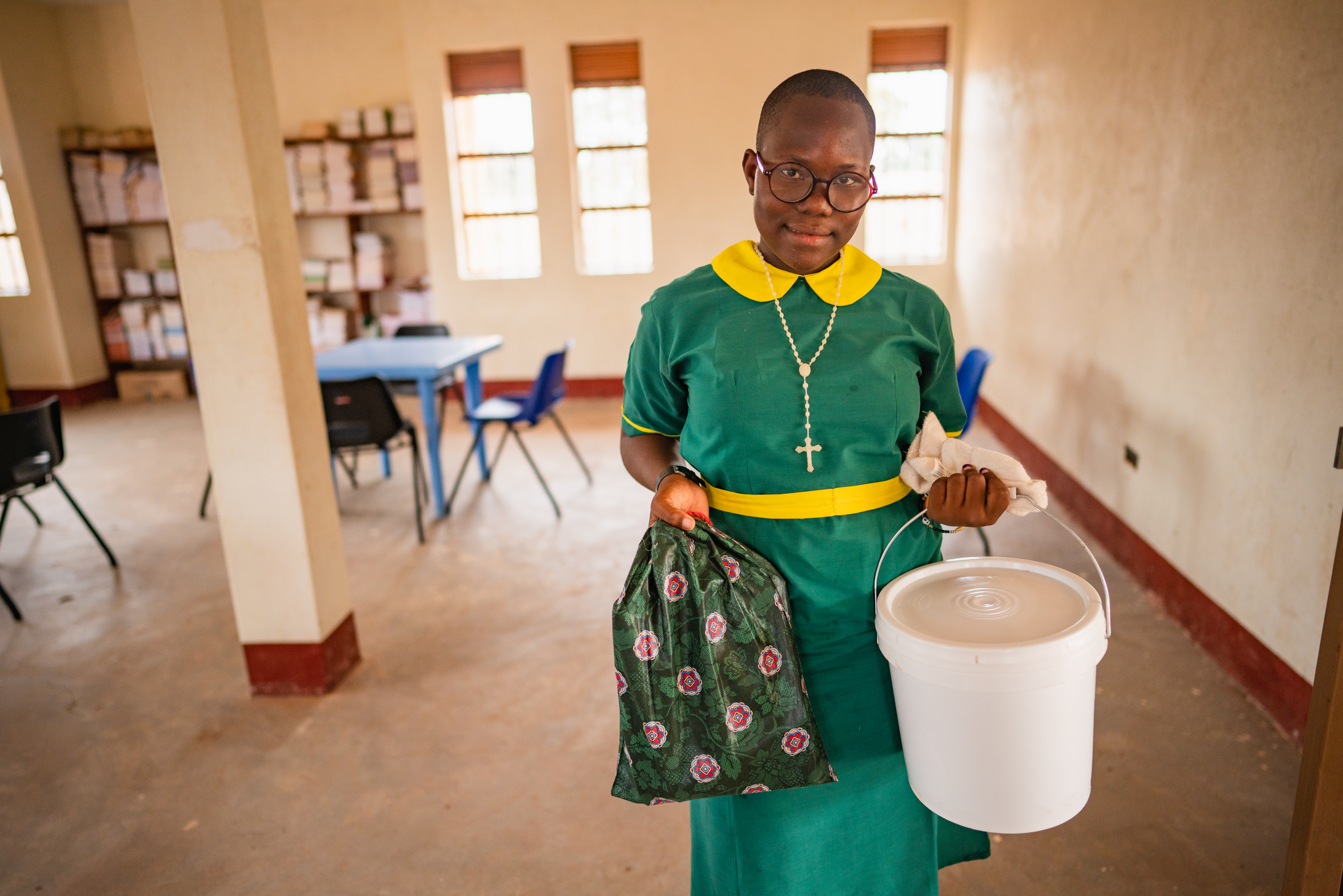 Picture of Amida Yunis James, student at Rumbek Comboni Primary School, holds her new dignity kit and school kit she just recieved.